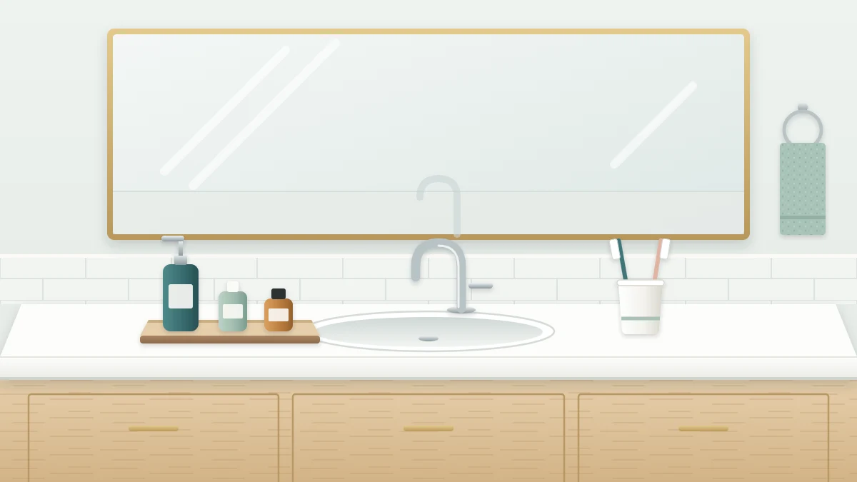 A clean white bathroom counter with an oval sink, a wooden tray holding a soap dispenser and two small bottles, and a cup with two toothbrushes