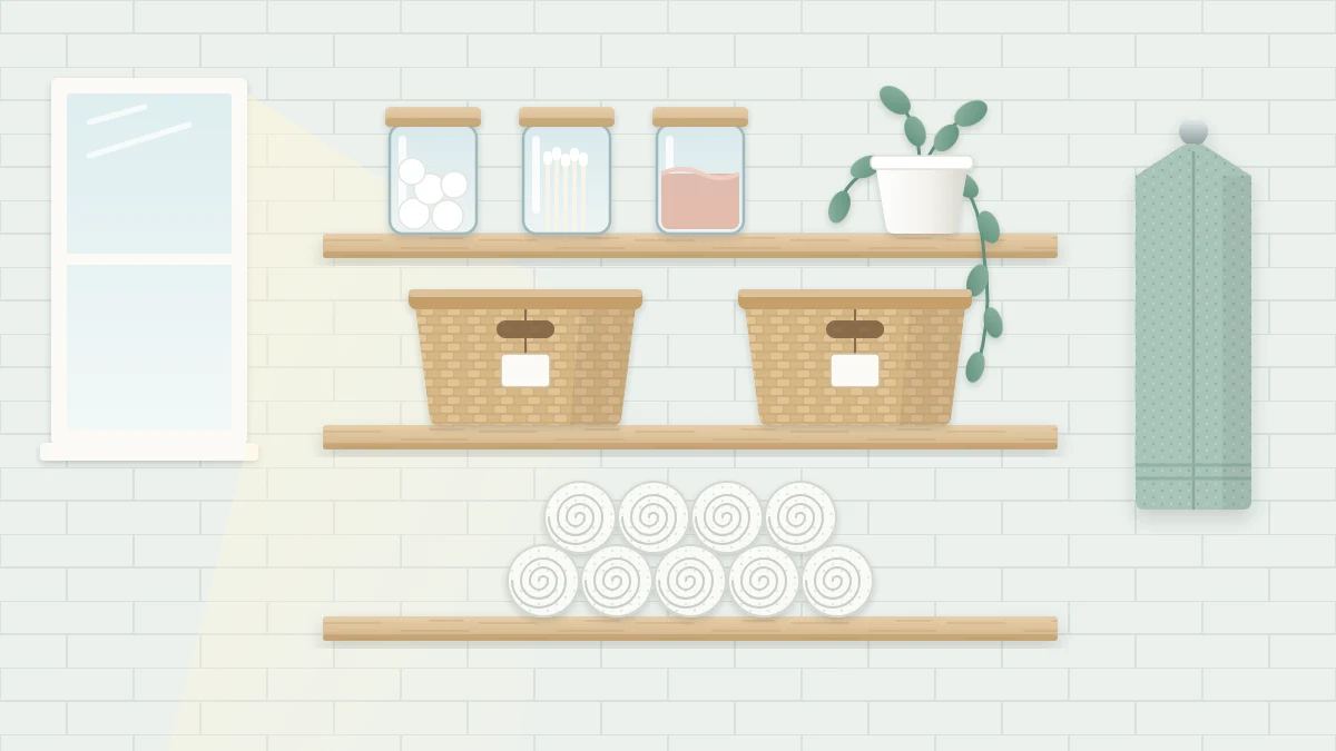 Three floating wooden shelves on a pale tiled wall with rolled white towels, two matching baskets, three glass jars and a small trailing plant