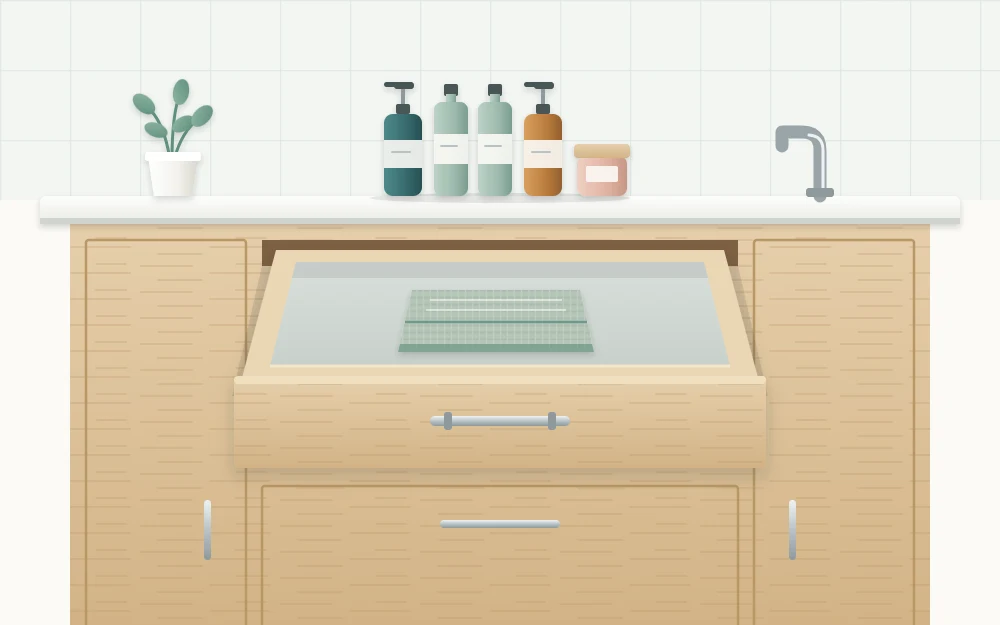 An emptied vanity drawer pulled open with a folded cloth inside it and a small group of bottles waiting on the counter