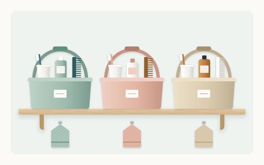 A shelf holding three handled caddies in different soft colors, each containing a toothbrush cup, a bottle and a comb