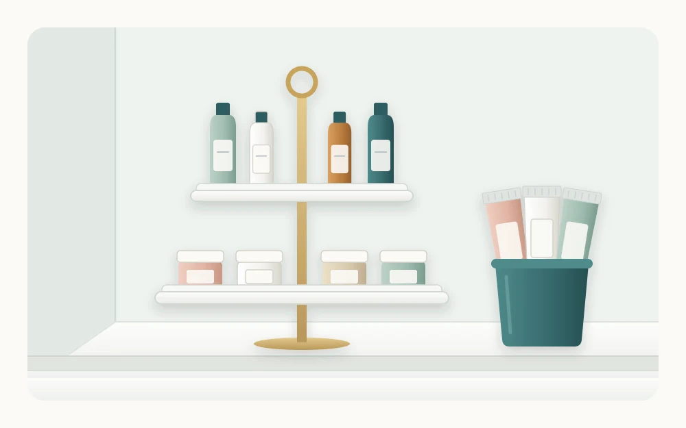 A two-tier stand on a counter corner with small jars below and slim bottles above, beside a cup holding three tubes cap down
