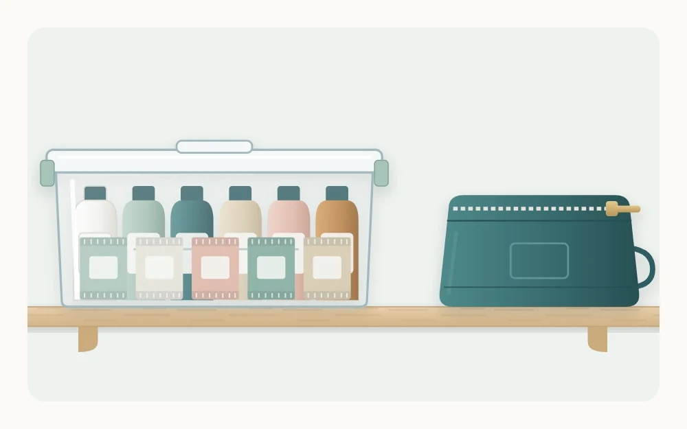 A lidded clear box of small travel-size bottles and sample packets beside a zipped travel pouch on a plain shelf