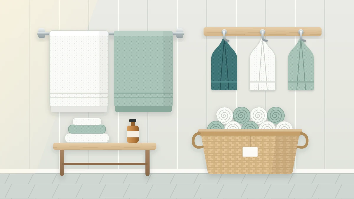 A bathroom wall with a towel bar holding two open bath towels, three hooks with hand towels and a woven basket of rolled towels below