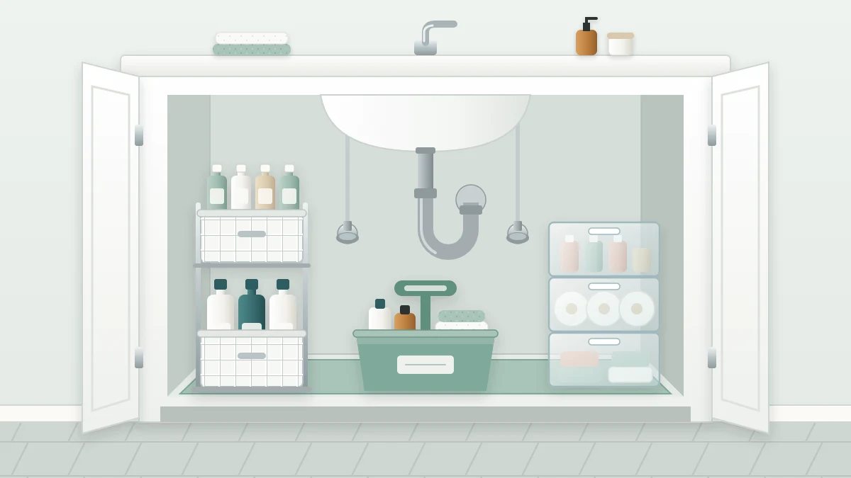 An open under-sink cabinet with a curved drain pipe in the center, a two-tier unit on the left, clear drawers on the right and a caddy in front