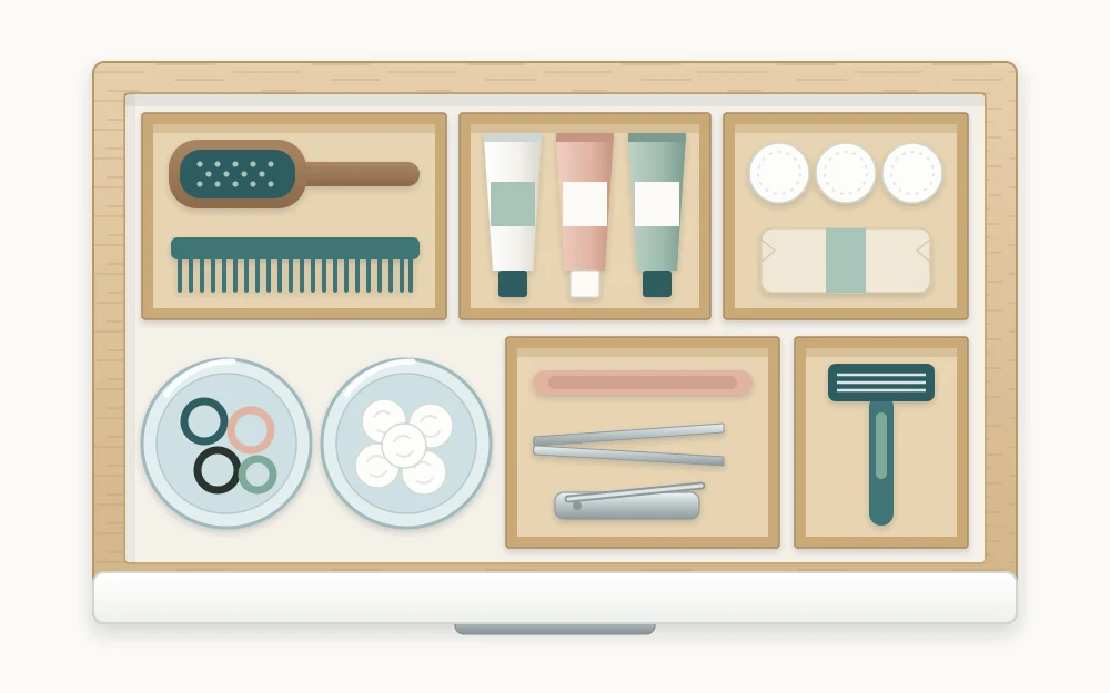 A vanity drawer organized with small open cardboard boxes and two drinking cups used as temporary dividers for grooming items